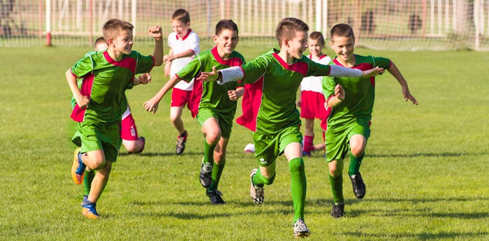 Jóvenes felices celebrando que hicieron un gol