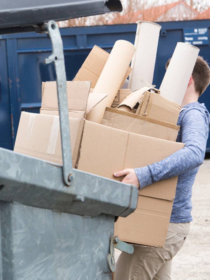 Una persona reciclando papel en un centro especializado mobile